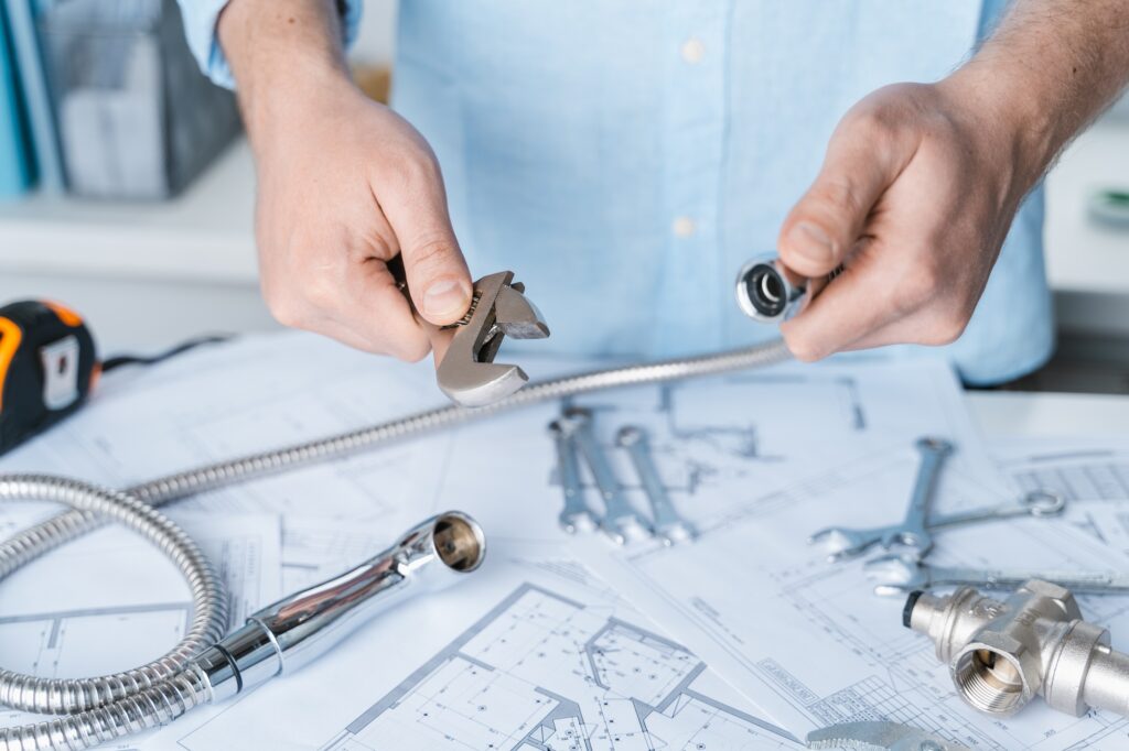 Plumbing project in house.Drawing,diagrams,plan of water supply of apartment,building.Man repairer