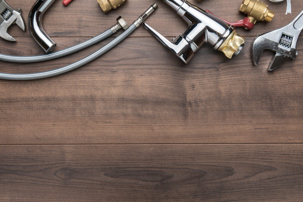 Top View Photo Of Plumbing Tools Over Wooden Background With Copy Space